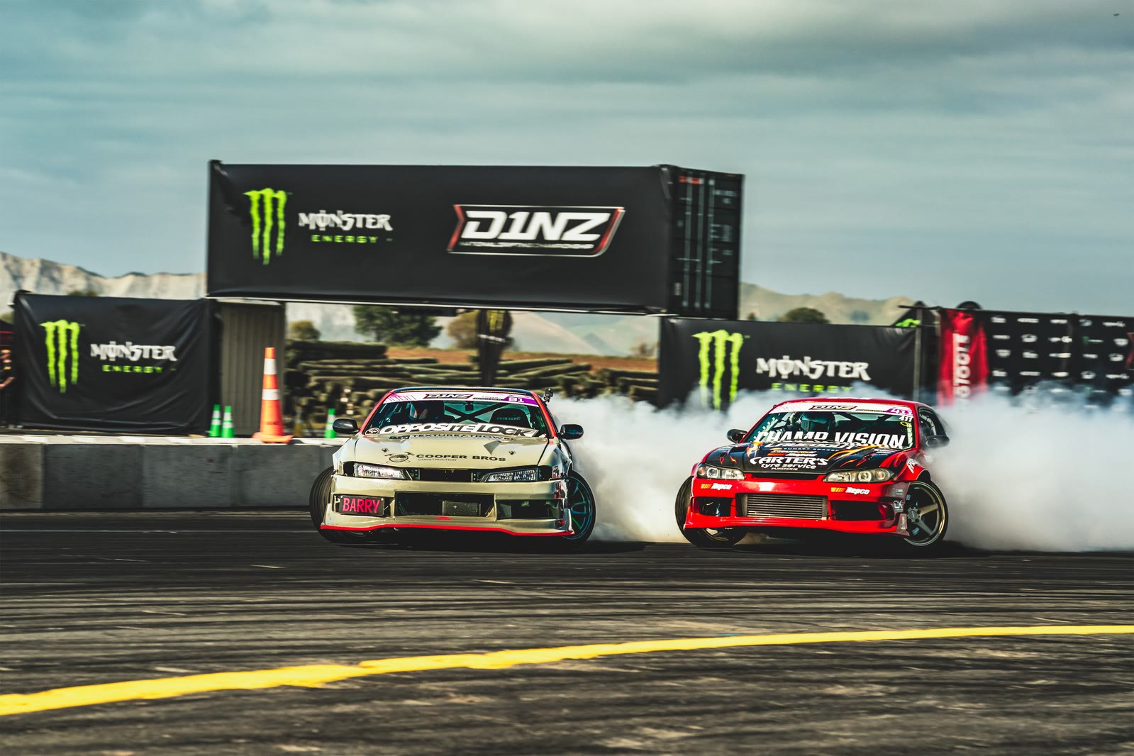 Monster Energy trackside signage as a car drifts past
