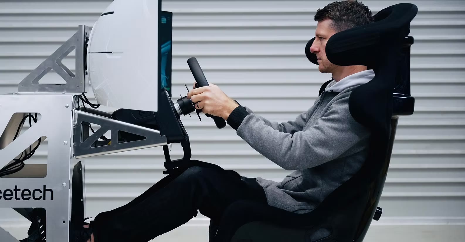 A competitor behind the wheel of the Virtual D1 sim rig